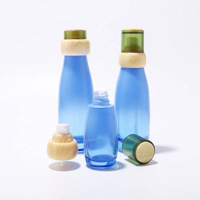 مجموعة زجاجات زجاجية مستديرة بالجملة مع غطاء من الخيزران في العناية بالبشرة لتغليف مستحضرات التجميل